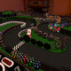A screenshot of a table covered in game pieces to create a makeshift race track.